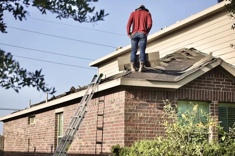 Professional roofer working on a residential roof in City Center